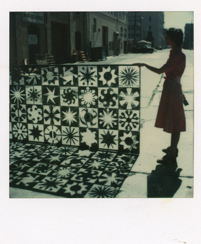 Lucia Eames standing alongside Sunburst Panel 1986. Photo © 2022 Eames Office LLC dba Lucia Eames Archives decohome.de