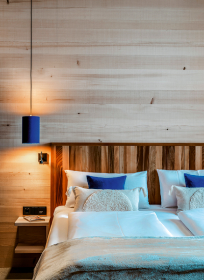Bett holzwand blaue kissen Zimmer Fuchsegg Eco Lodge © www.guenterstandl.de (32) decohome.de